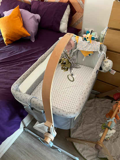 Little Dutch wooden musical mobile mounted on a Chicco Next2Me Dream bedside cot using the CribClamp baby mobile adapter.