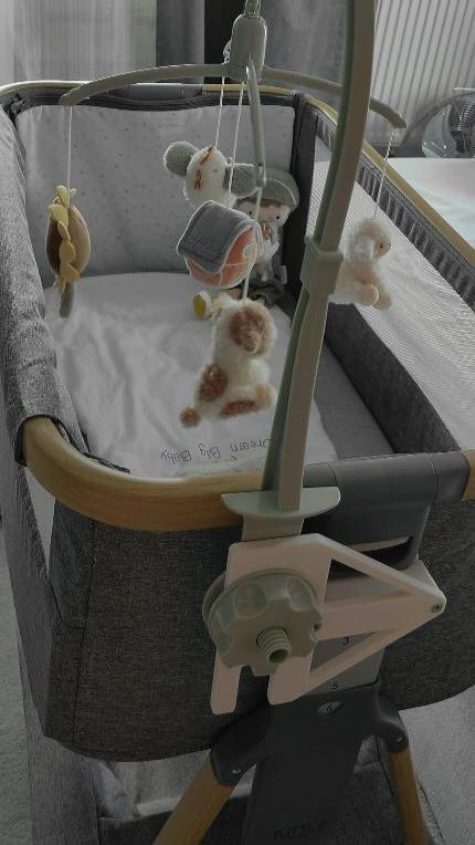 Musical mobile adapter attached on the  Tutti bambini Cozee bedside crib co sleeper with mama and papas musical mobile soothervertical view full crib image